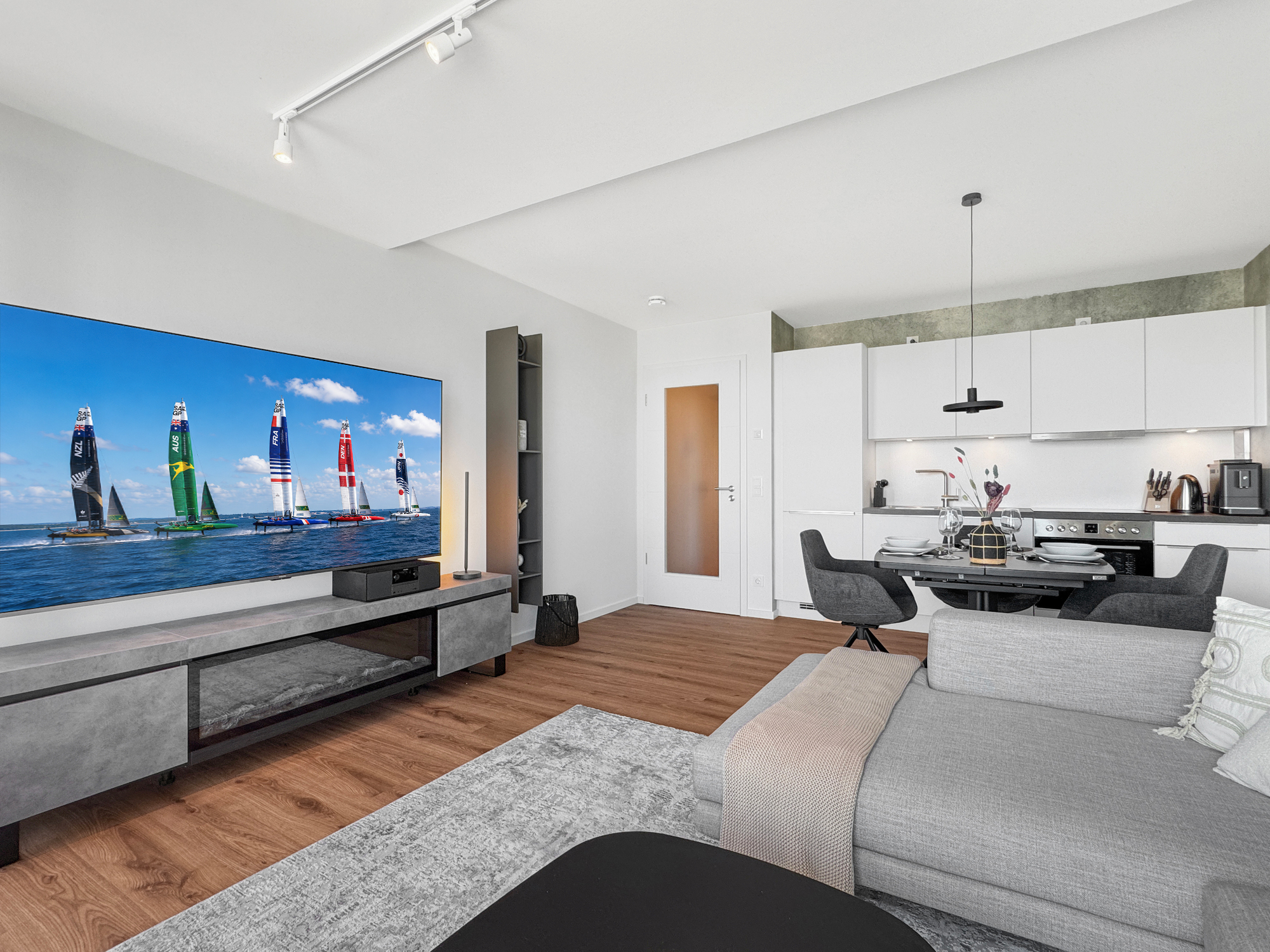 Sideboard mit Dekokamin und großem 70 Zoll Smart-TV in einer löffelfertig eingerichteten Ferienwohnung